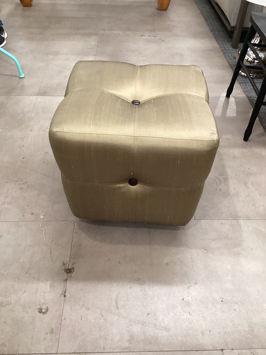 small golden fabric ottoman